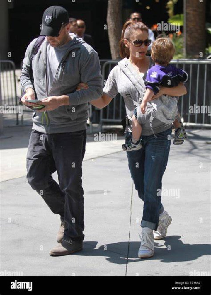 Alyssa Milano carries her son Milo Thomas as she leaves the Los Angeles